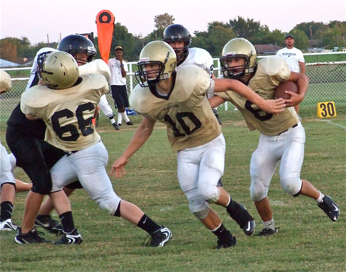 Image: Follow us — Gladiators Jake Escamilla(66) and lead blocker Chase Hamilton(10) pave the way for quarterback Tony Wooldridge(6).