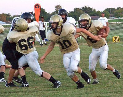 Image: Follow us — Gladiators Jake Escamilla(66) and lead blocker Chase Hamilton(10) pave the way for quarterback Tony Wooldridge(6).