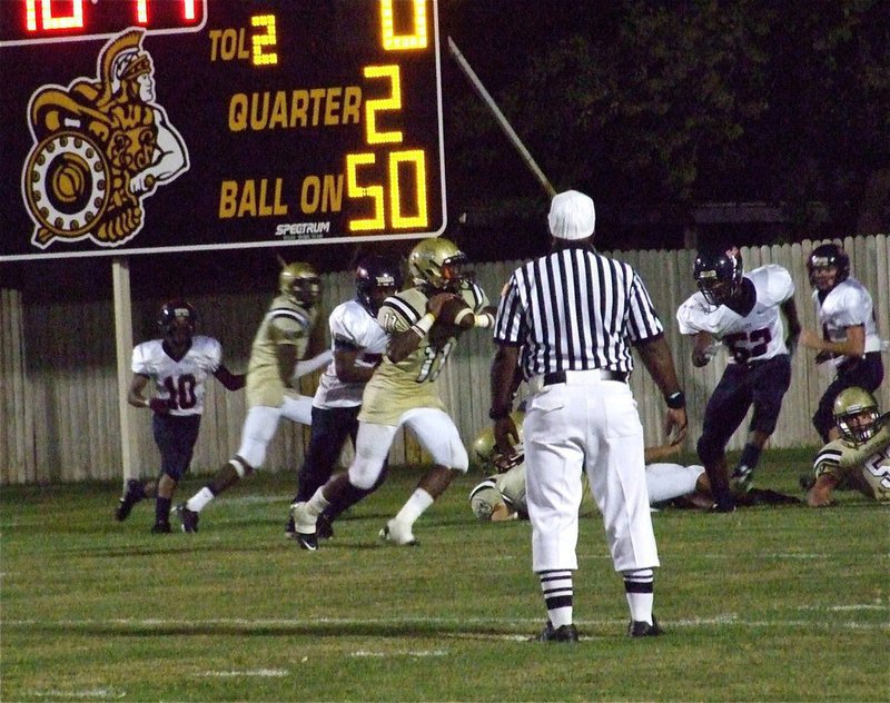 Image: Can’t stop Senio — Gladiator quarterback Jasenio Anderson(11) rolls out to pass into the endzone against the Red Oak Life Mustangs.