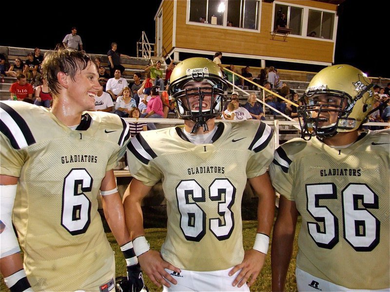 Image: Italy puts up big numbers — Gladiators Jase Holden(6) and Omar Estrada(56) celebrate their winning by Brandon Souders’ jersey number, 63-0 over the Red oak Life Mustangs.