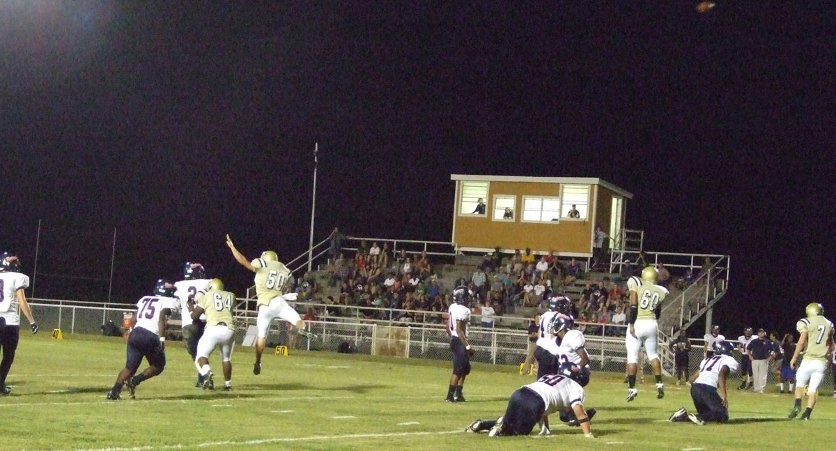 Image: Pressure on the passer — Ethan Simon (50) and Bobby Wilson (64) force the Mustangs quarterback to throw the ball away.