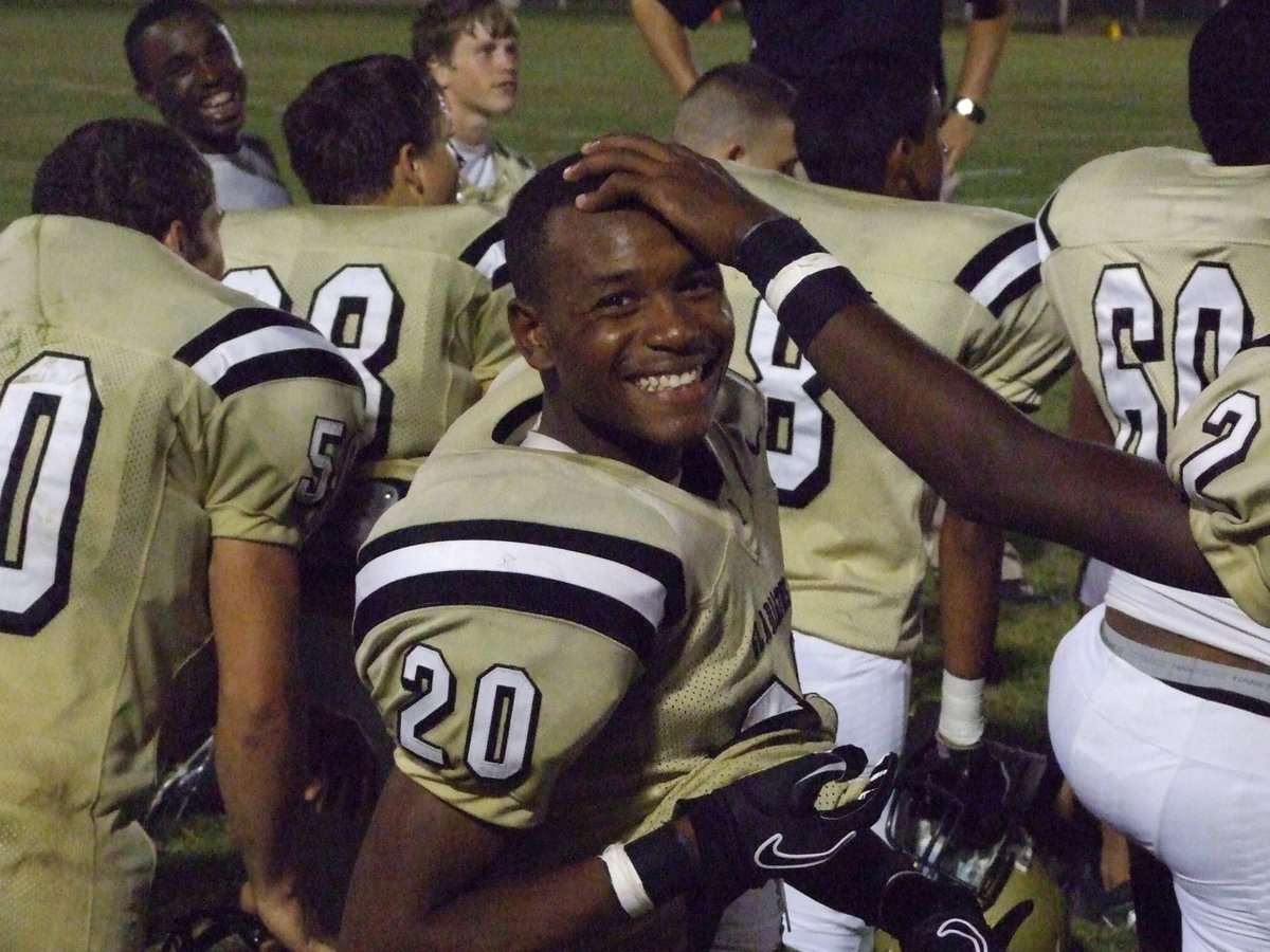 Image: Smile, you’re on candid camera — De’Andre Sephus (20) gets a helpful nudge from teammate Heath Clemons (2) who points him toward the italyneotribune.com cameras after their big win over the Mustangs.
