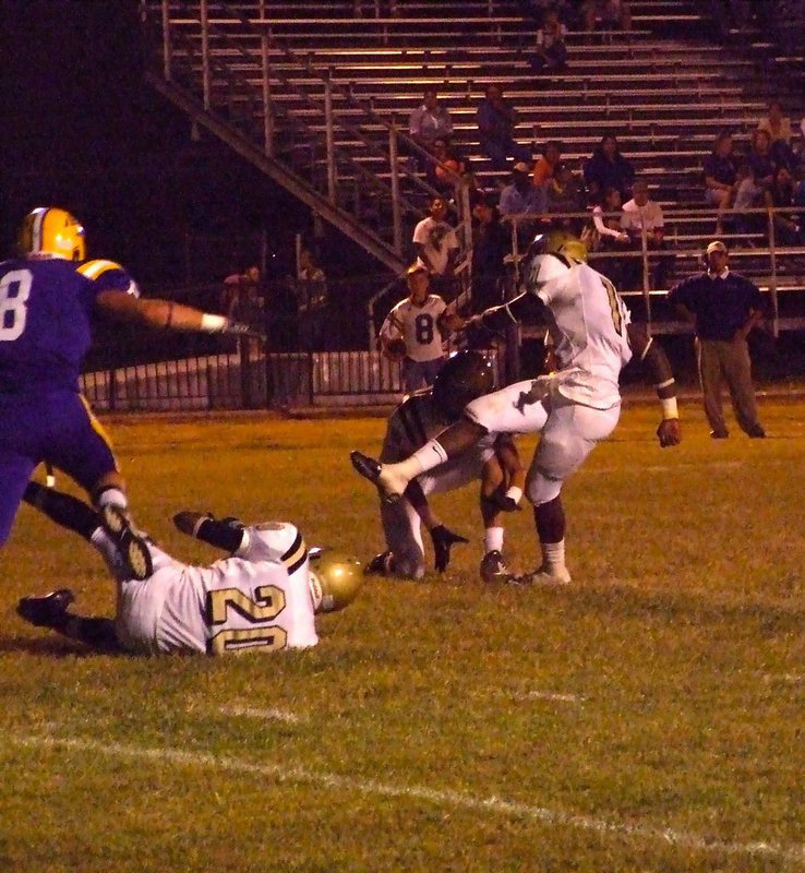 Image: The kick to tie — De’Andre Sephus(20) blocks, Jase Holden(6) holds and Jasenio Anderson(11) kicks thru the extra point to tie the game 7-7.