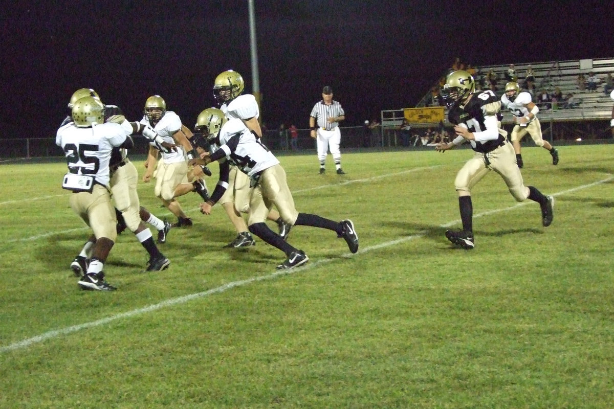 Image: Defensive tackle — The Gladiator defense moving quickly as a team to the ball.
