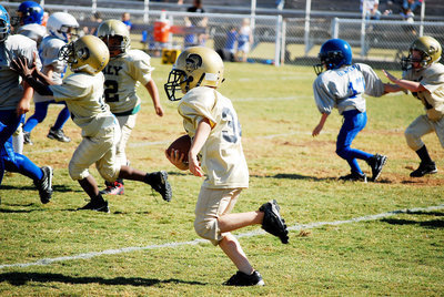 Image: Clear for takeoff — Ricky Pendleton, Nicolas Gomez and Levi Stark clear the way for running back Corbin Schrotke.