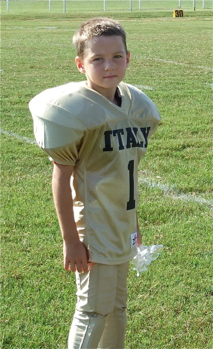 Image: Taylor Sparks — Kindergartener Taylor Sparks receives his gift bag after the Bantam (K-2nd) Homecoming game against Ferris.