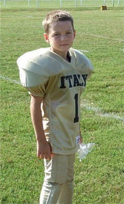 Image: Taylor Sparks — Kindergartener Taylor Sparks receives his gift bag after the Bantam (K-2nd) Homecoming game against Ferris.