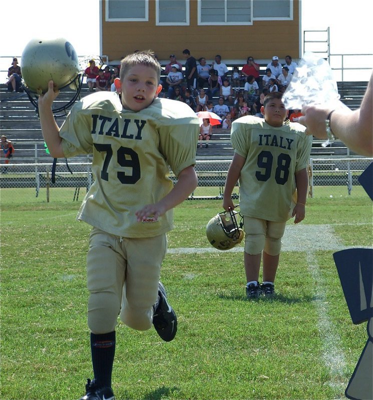 Image: Homecoming goodies — Italy’s Minors’ players receive a gift bag after their 24-14 Homecoming win over Ferris.