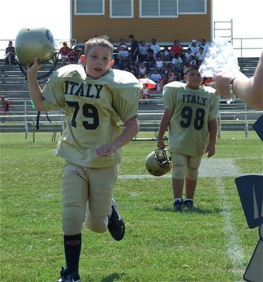 Image: Homecoming goodies — Italy’s Minors’ players receive a gift bag after their 24-14 Homecoming win over Ferris.