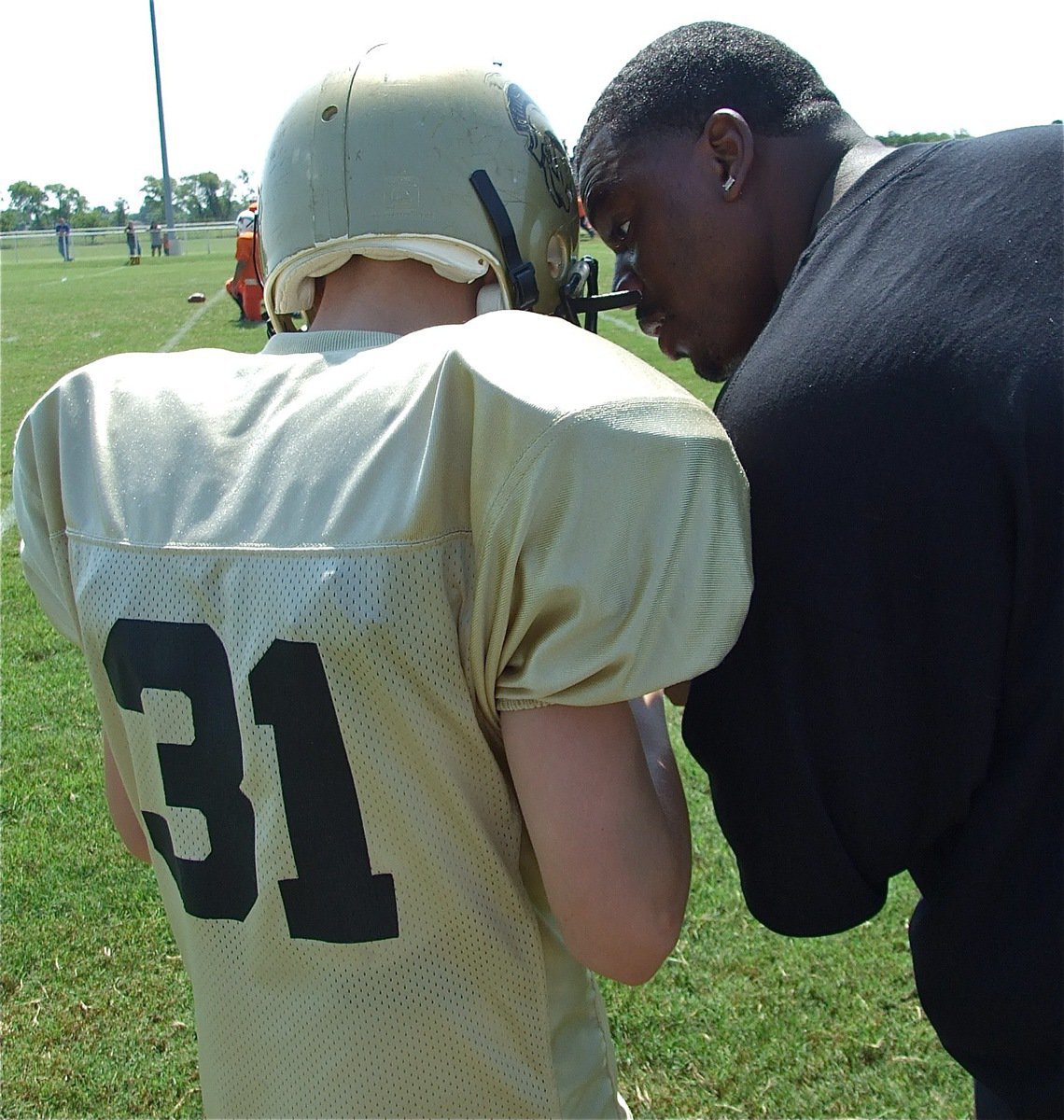 Image: Riddle gets the play — Clay Riddle gets the play call from the Majors’ assistant coach Edwin Wallace. Clay’s homecoming day performance marks the first time in twenty years a Riddle has played football on Willis Field.