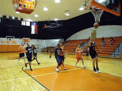Image: Dome tricks — Colton Campbell(1) leaves the ball off the backboard for teammate Devonta Simmons(16) who went for the dunk.
