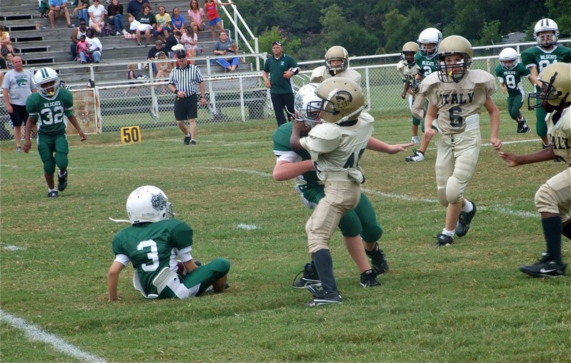 Image: Be afraid! — IYAAs Tyvon Gates forces the Wildcat kick returner to take a seat.