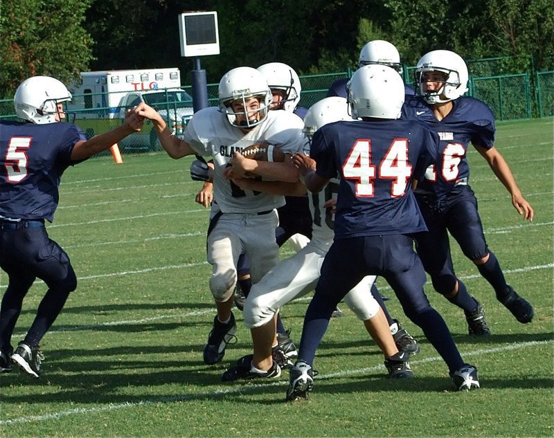 Image: Ryan Connor(17) tries to break away from the Mustangs — Italy’s Junior High quarterback Ryan Connor(17) follows the lead block of Coby Bland(10) thru a herd of Red Oak Life Mustang defenders in Dallas.