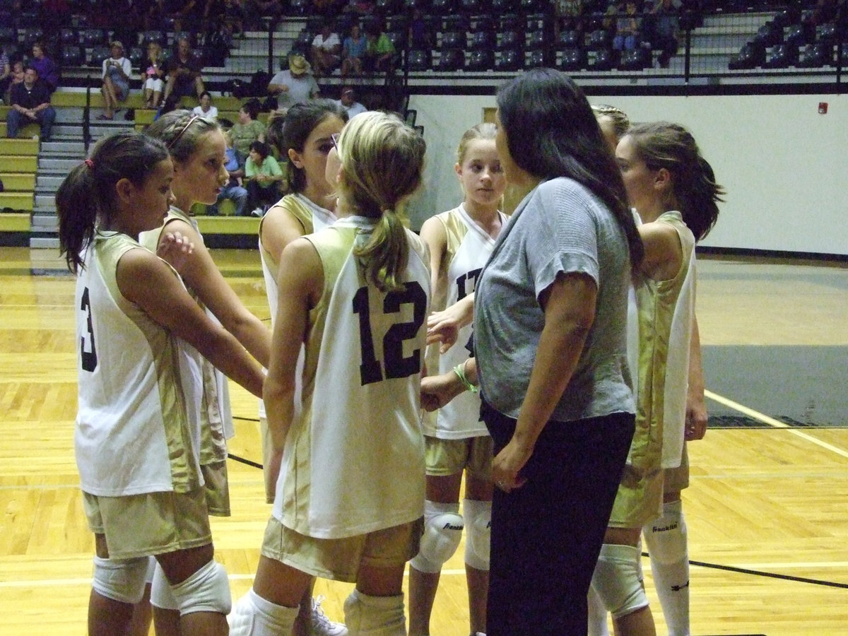 Image: 7th A team huddles with coach Tina Richards — “I love it when a plan comes together,” is the famous line from the A-Team! The Lady Gladiators battled Grandview Lady Zebras on Monday night at the dome.