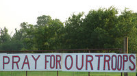 Image: Support for our nation — Church in the Wildwood Ministries hung this sign on the highway for passersby to see and acknowledge.  One person certainly did.