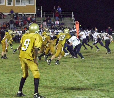 Image: End of the line —  #9 Simmons covers the corner while #63 Souder and the rest of the line force their way into the Life Charter offense for the stop.