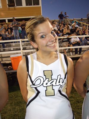 Image: She’s a hoot! — IHS Cheerleader Morgan Cockerham puts on her happy face during the game.