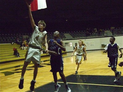 Image: Justin scores — Justin Wood(4) attacks the rim against Dallas life.