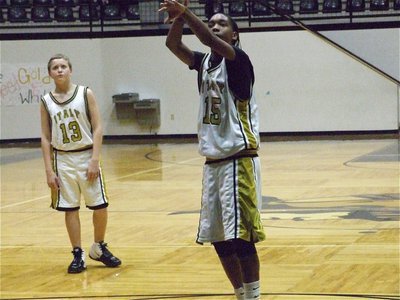 Image: Treyvon from the line — Treyvon Robertson(15) sinks a free throw while Bailey Walton(13) gets ready to play defense.