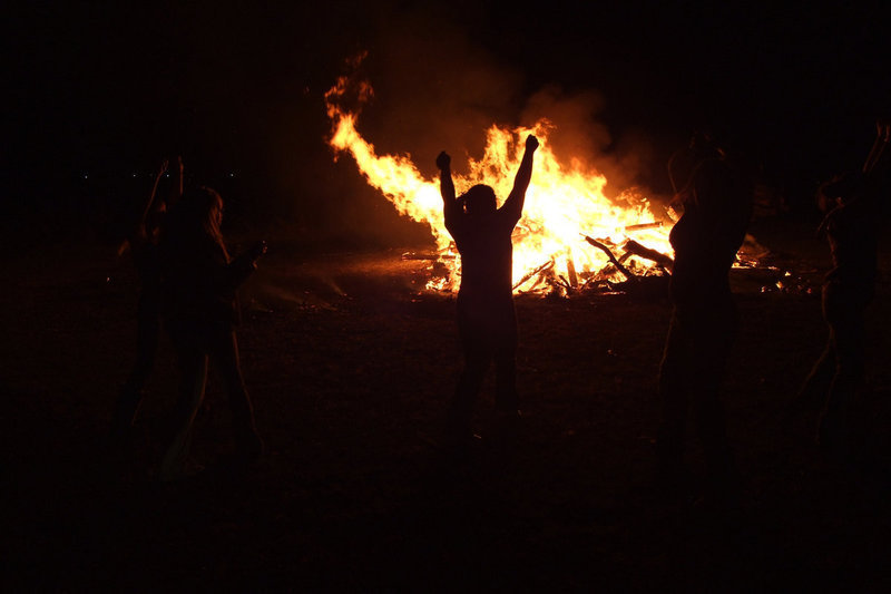 Image: IHS cheerleaders — The firelight is the backdrop for the fun.
