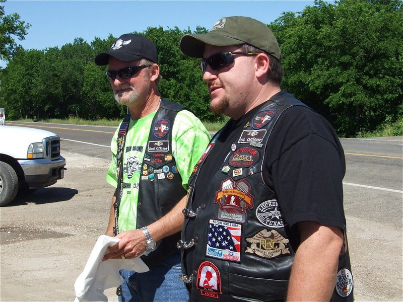 Image: Here we go — Mike Ritchy and Shay Krnavek pass out the “Adopt-a-Highway” trash bags and protective vests.