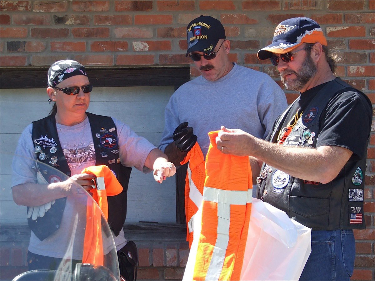 Image: We can do this — Cheryl, Barry and Bobby trade in their black leather jackets for bright orange protective vests.