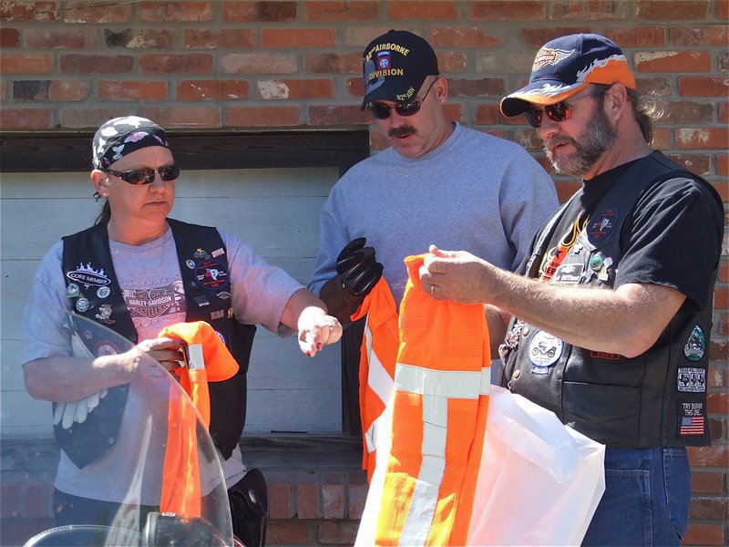 Image: We can do this — Cheryl, Barry and Bobby trade in their black leather jackets for bright orange protective vests.