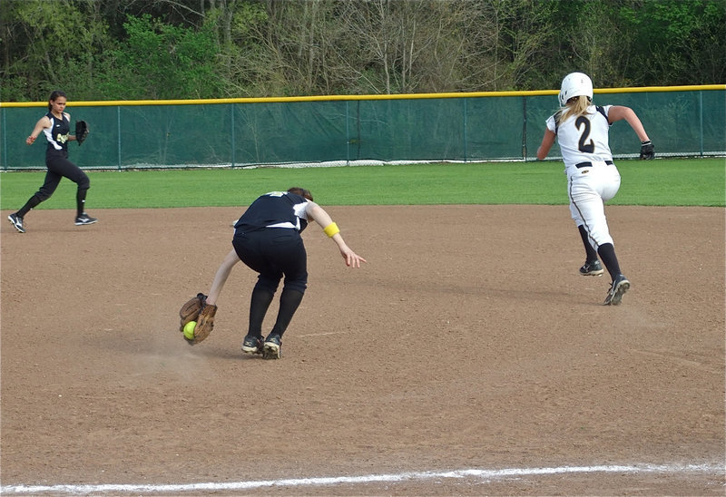 Image: Backhanded out — First baseman Drew Windham backhands a grounder and then throws to shortstop Anna Viers at second base to get the Lady Jag runner out.