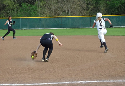 Image: Backhanded out — First baseman Drew Windham backhands a grounder and then throws to shortstop Anna Viers at second base to get the Lady Jag runner out.