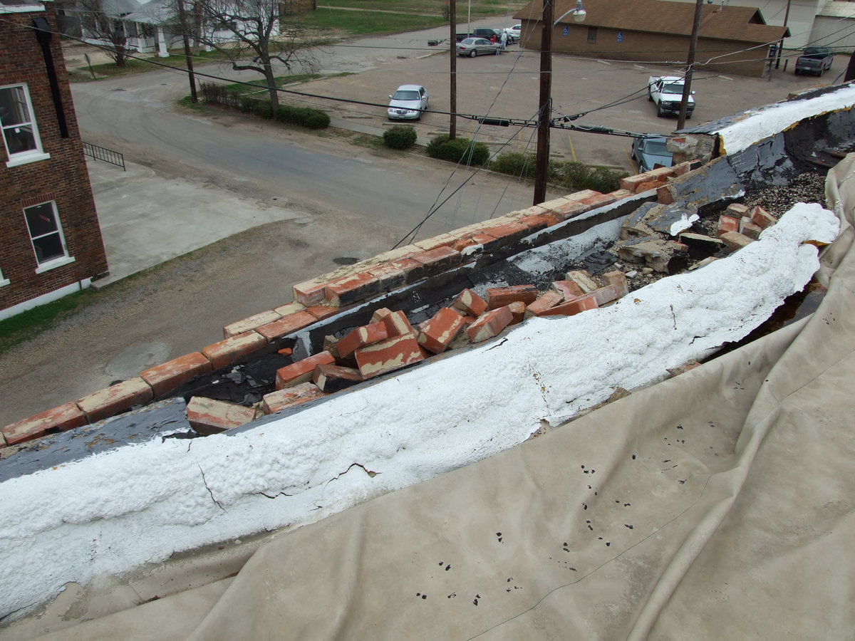 Image: Crumbling Wall — Wind and erosion is causing bricks to crumble away.