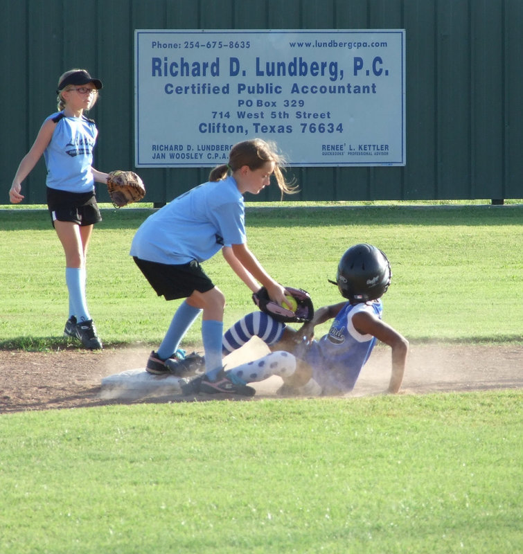 Image: Lindale gets the tag — Milford and Lindale have a battle ‘til the finish Monday night. Milford’s Jace McIntyre uses her slide.