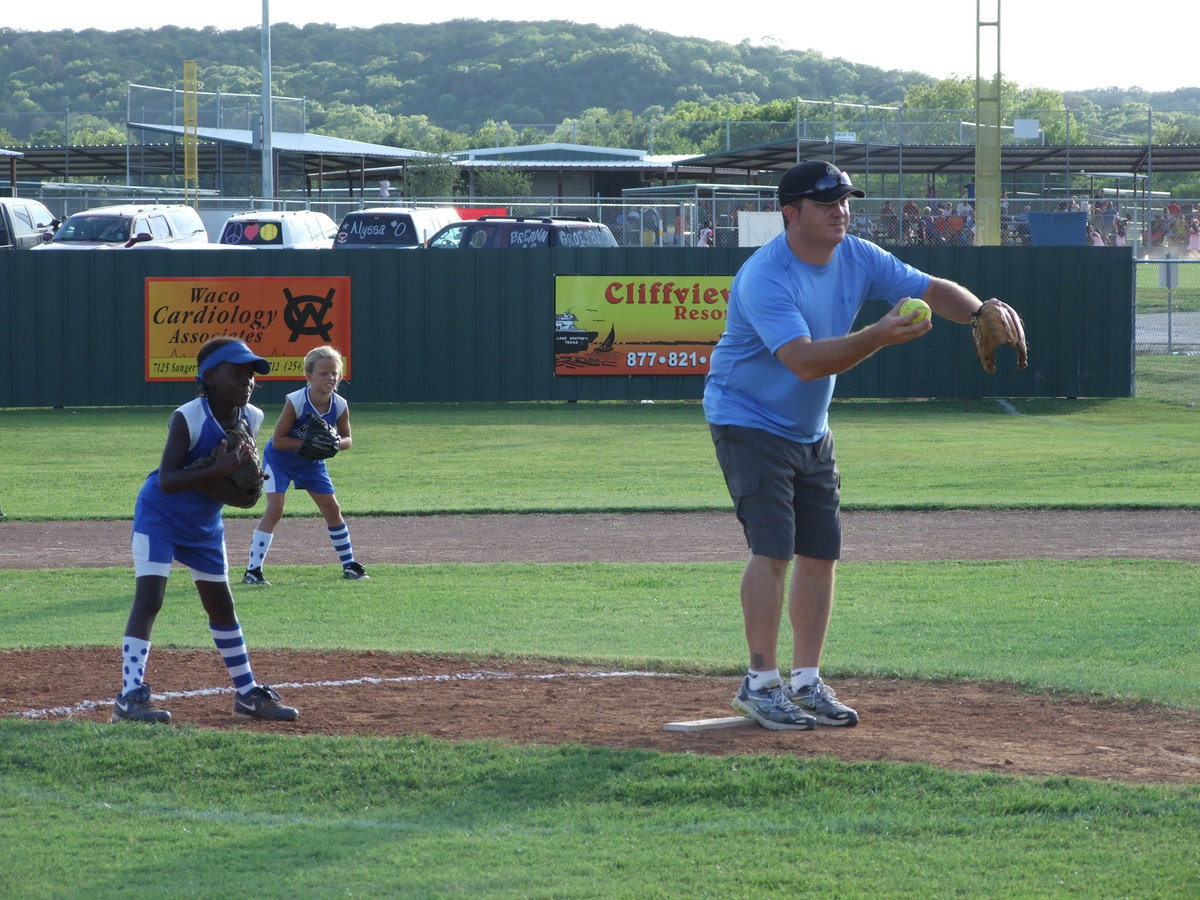 Image: We are ready — Milford gets down and ready as the Lindale coach pitches to his team. Milford’s Markia Houston and Alex Jones are ready to play.