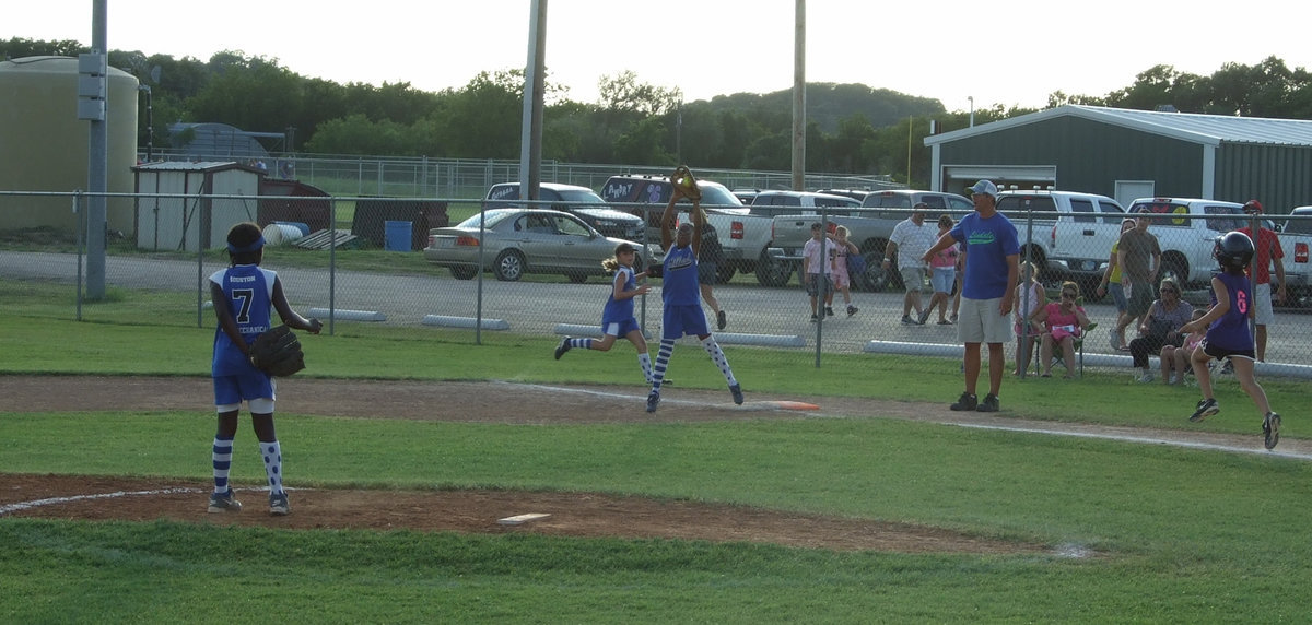Image: Yeah, she caught it — Jace McIntyre caught this ball easily at first base.  Markia Houston and Gracie Whittington back her up.