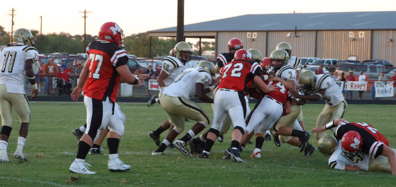 Image: Help from friends — Italy’s Kyle Wilkins(7), Heath Clemons(2), Bobby Wilson(64) and Larry Mayberry(77) bring down Maypearl’s quarterback Conner Vaughan(14).