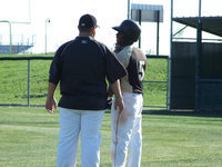 Image: Coach and Desmond — Desmond Anderson and head coach Matt Coker talk a bit before his at-bat.