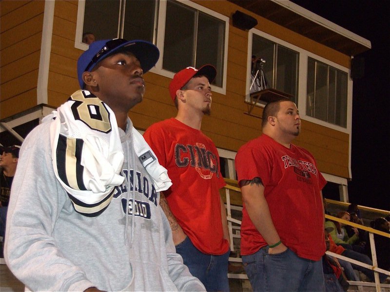 Image: All eyes on JV — Senior Desmond Anderson(8) intently watches the JV game along with other Gladiator Fans.
