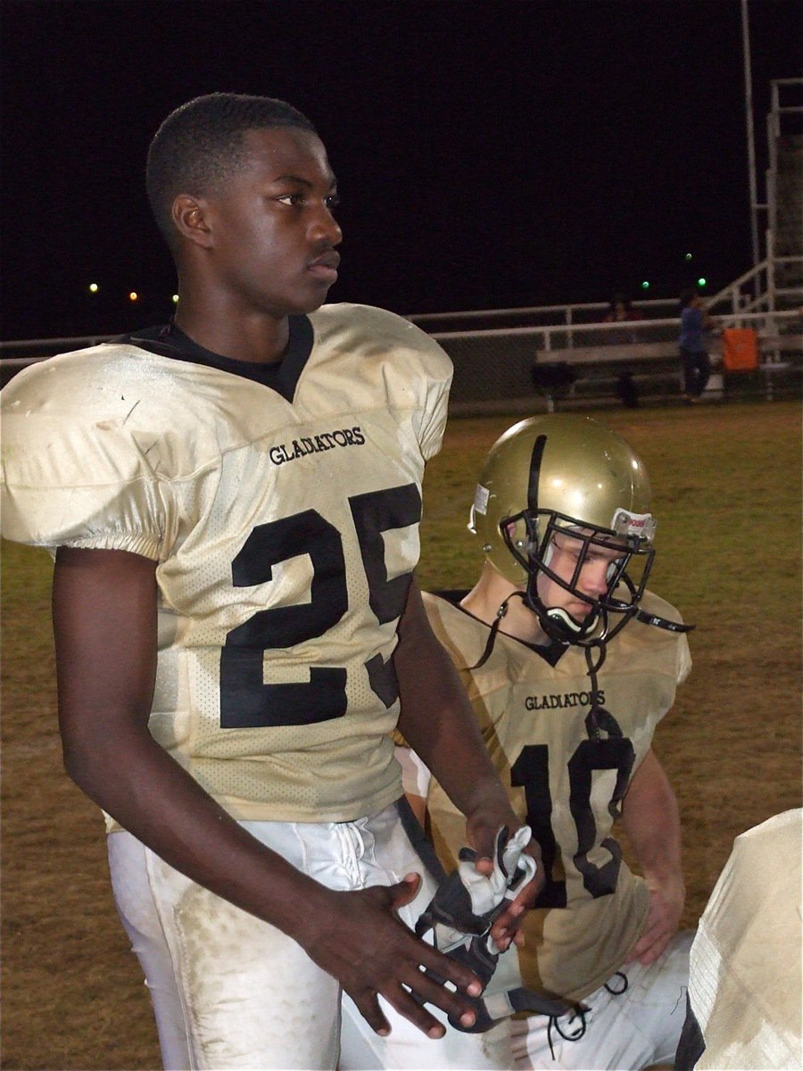 Image: Corrin and Chase — Corrin Frazier(25) and Chase Hamilton(10) listen to Coach Craig Bales and Coach Robert Sollers after their win over the Wampus Cats.