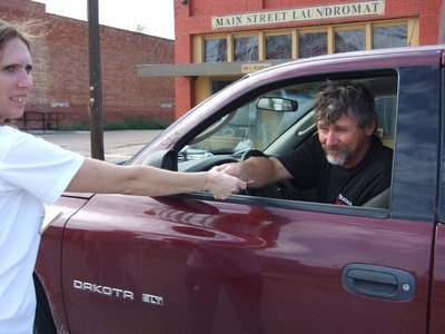 Image: Jerry Huffman gives donation — Jerry Huffman stops to donate. “Fill the Boot” volunteer Kelly Svehlak is there to accept it.