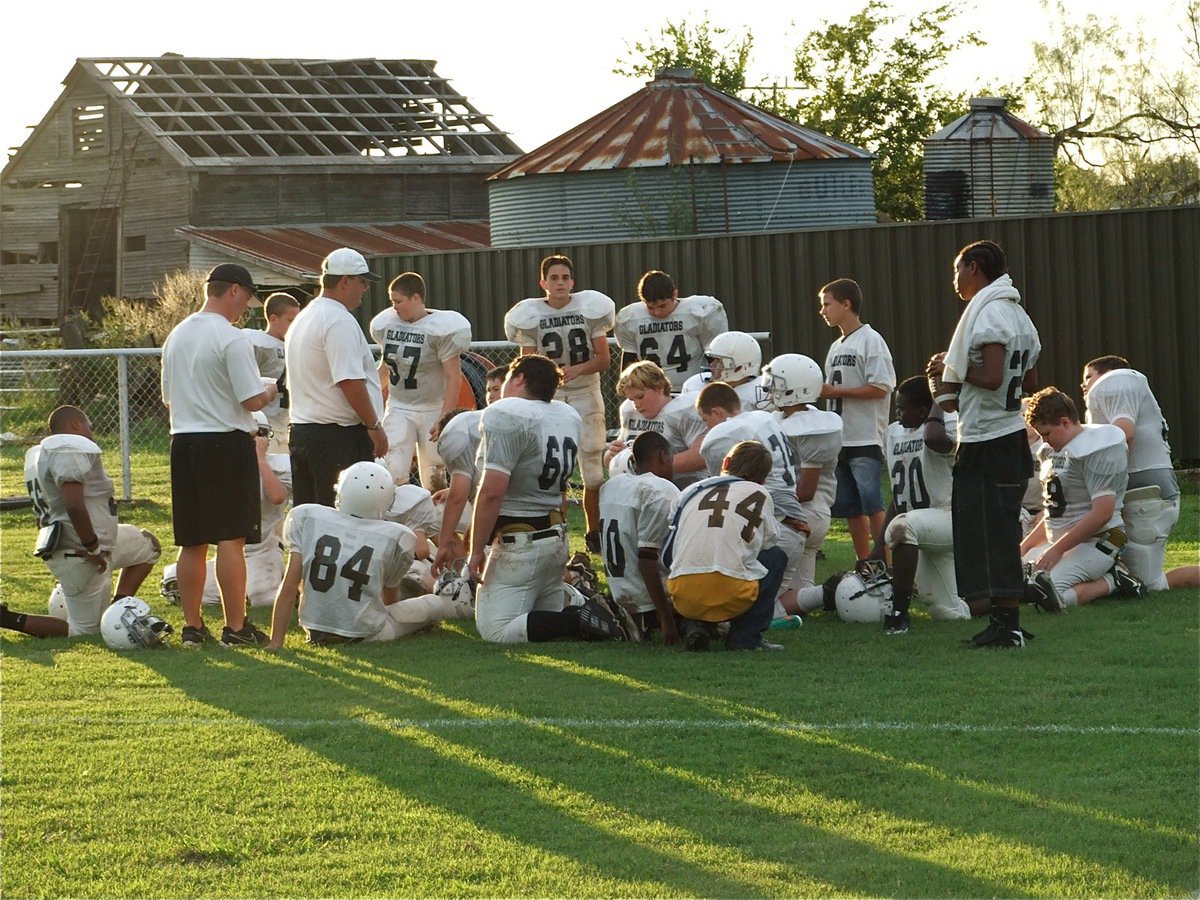 Image: Halftime in the country — The Italy coaches and players take a break amidst a rustic backdrop.