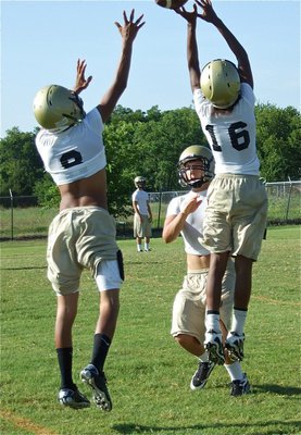 Image: Closing in — Trevon Robertson(16) and Kyle Jackson disrupt a pass attempt to Eddie Garcia.