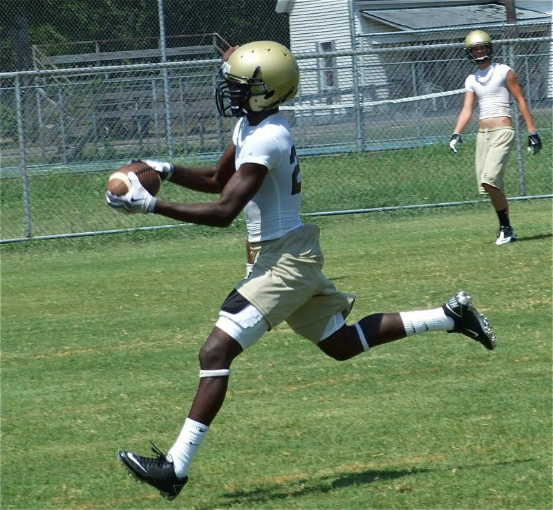 Image: Nice catch — Corrin Frazier hauls in a pass while fellow receiver Jase Holden looks on.