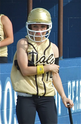 Image: Dressing for battle — Lady Gladiator Drew Windham gets ready to bat.