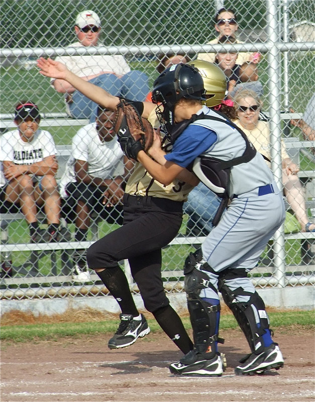 Image: She’s safe! — Anna Viers(43) reaches home plate before colliding with the Frost catcher for an inside the park homerun.