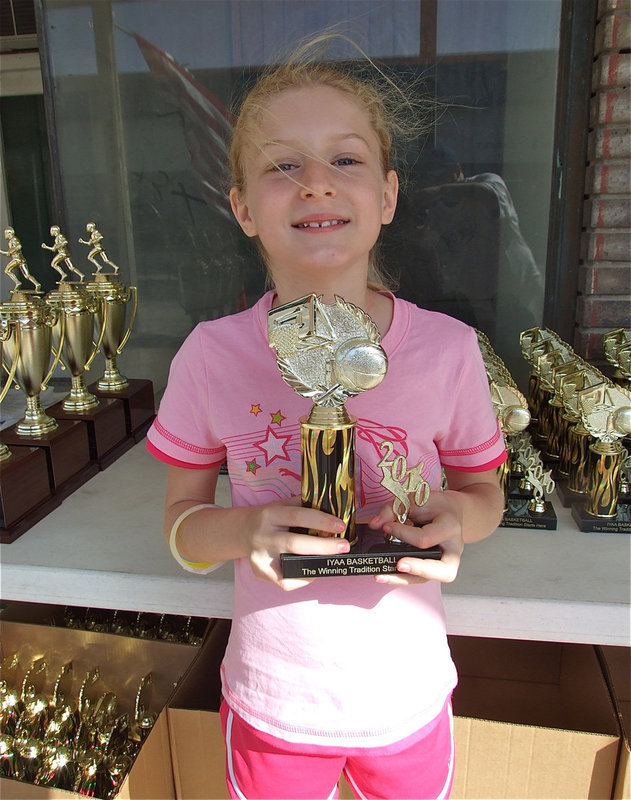 Image: Courtney Riddle — Courtney Riddle stoped by during the Game On Athletics grand opening to receive her IYAA Basketball Trophy and tour the new print shop.