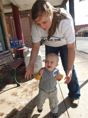 Image: Kace steps up his game — Kace can hardly contain his excitement during the Game On Athletics grand opening and takes a victory lap in front of the new print shop with mom Julia.