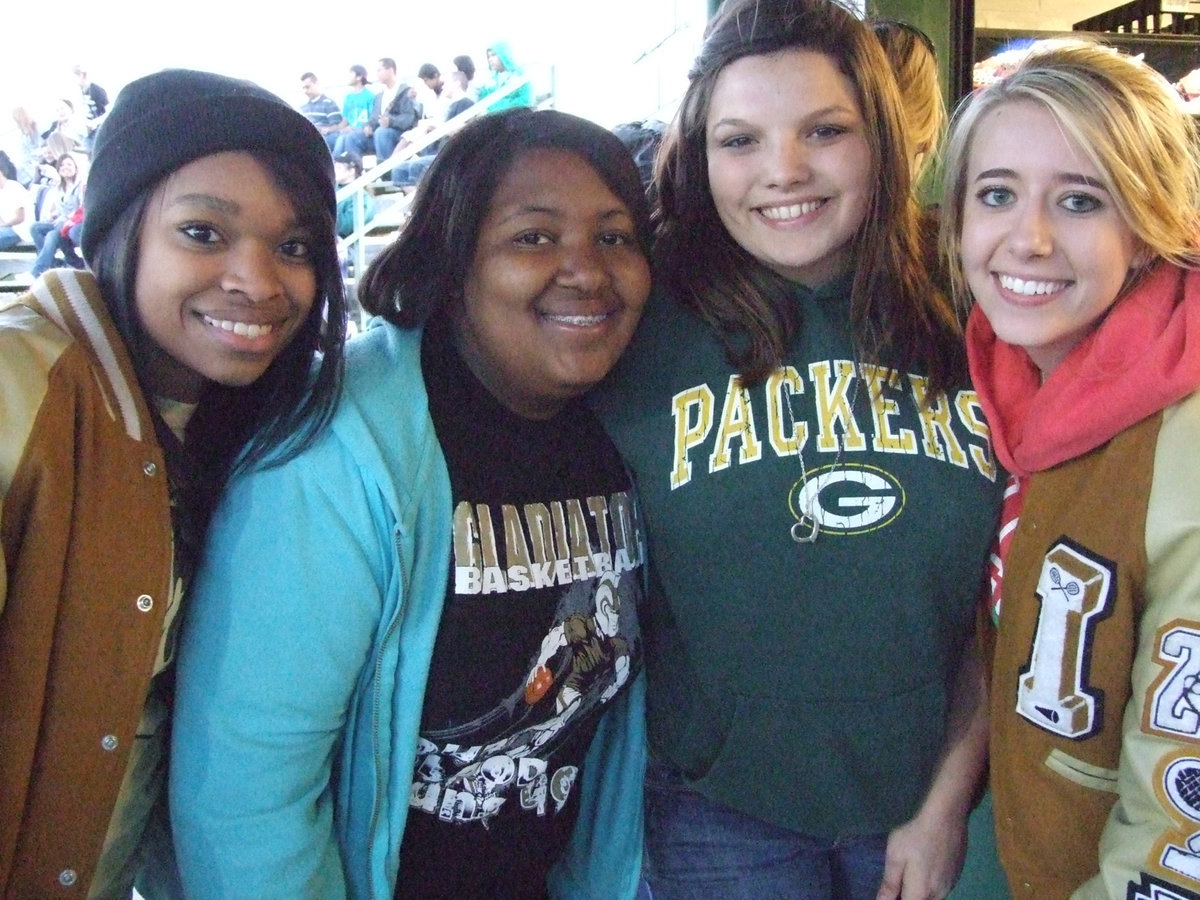 Image: All winners — Kyonne Birdsong, Ka’Deesha Davis, Cori Jeffords and Lexi Miller gather at the concession stand to help Davis show her winning coupon. She won a free hamburger from the “Gladiator Grill” on Friday night.