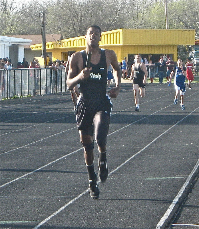 Image: Isaac kicks — John Isaac kicks strong down the home stretch.