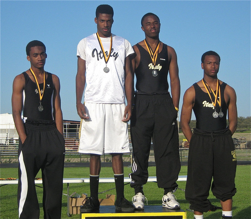 Image: Proud on the podium — Heath Clemons, John Isaac, Jasenio Anderson and De’Andre Sephus get it done in the 4×200, finishing in 3rd Place.
