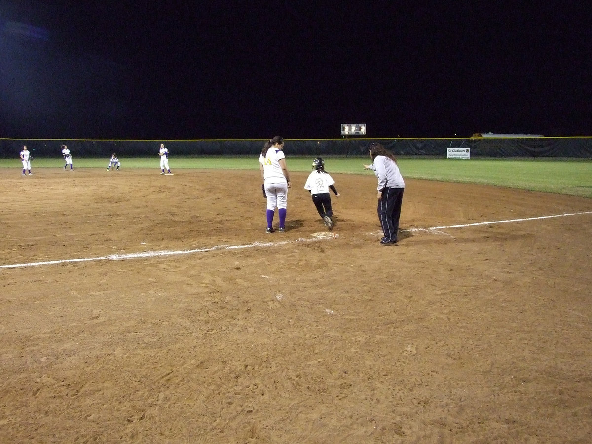 Image: Go, Pita! — Junior Lupita Luna hits one in the air and steals second.