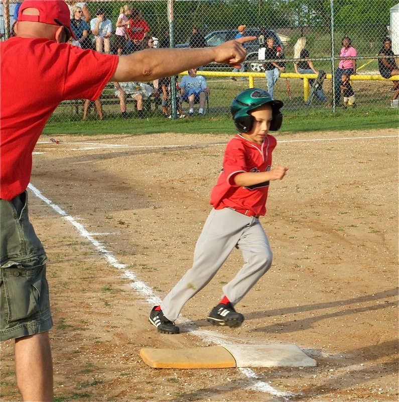 Image: Run, Son, Run! — First base coach Chad Hamby directs his son, Grant Hamby, to second base after Grant hit one into the outfield.